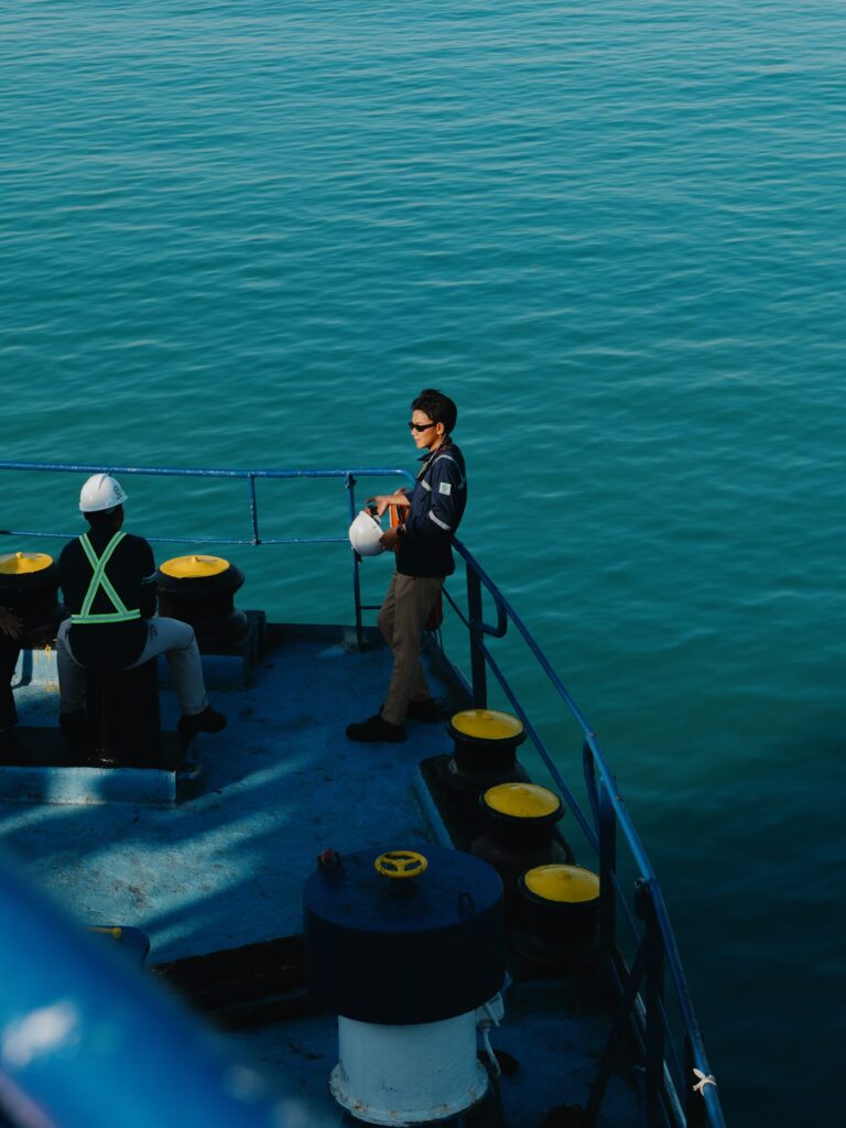 Seafarers on a ship’s deck overlooking the sea